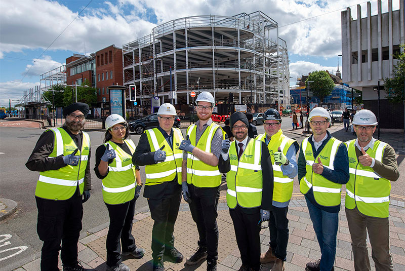(L-R): City Learning Quarter partners come together to celebrate the completion of steels works on the new city centre campus – Ninder Johal DL, Wolverhampton City Investment Board Chair, Jas Dolphin, Area Lead for the Black Country in the Cities and Local Growth Unit: a partnership between the Department for Business and Trade and the Ministry of Housing, Communities & Local Government, Paul Davies, City of Wolverhampton College Director of Finance, Cllr Chris Burden, City of Wolverhampton Council Cabinet Member for City Development, Jobs and Skills, Warinder Juss, MP for Wolverhampton West, David Byrne, McLaughlin & Harvey Ltd Operations Manager, Alex Omelchuk, Turner & Townsend Project Manager, and Julian Kirkpatrick, Adult Education Wolverhampton Senior Manager for Curriculum and Quality.