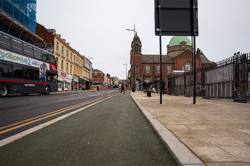 Photos of the improved Darlington Street paving, street furniture and active travel cycle lanes