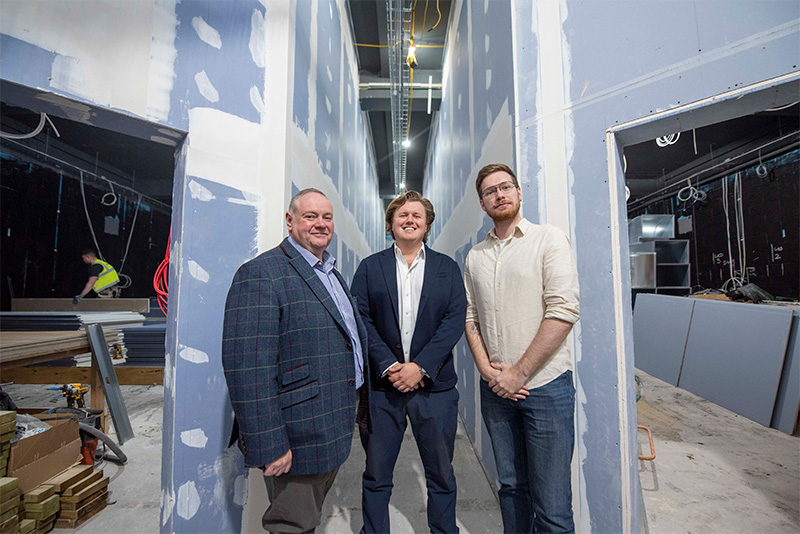 (L-R): Council Leader, Cllr Stephen Simkins, Director at PDJ Management, James Jervis, and Cabinet Member for City Development, Jobs and Skills, Cllr Chris Burden, stand between screens 1 and 2 of the new Lockworks Cinema.